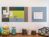 Felt Right wall art design using blue, grey, green, and cream shades of felt tiles that are pinable with pictures and a calendar above a table with fruit and jars on it.