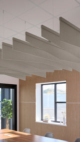 Light brownish-grey acoustic ceiling blade baffles suspended from the ceiling, installed in a conference room. Felt Right's acoustic blade baffles absorb 65% of sound waves, making office spaces quieter and feel more calm.