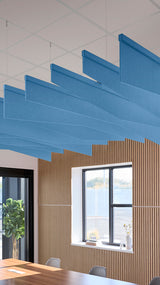 Bright blue acoustic ceiling blade baffles suspended from the ceiling, installed in a conference room. Felt Right's acoustic blade baffles absorb 65% of sound waves, making office spaces quieter and feel more calm.