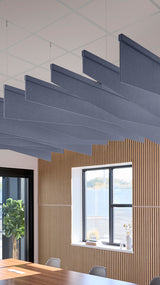Indigo blue acoustic ceiling blade baffles suspended from the ceiling, installed in a conference room. Felt Right's acoustic blade baffles absorb 65% of sound waves, making office spaces quieter and feel more calm.