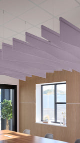 Light purple acoustic ceiling blade baffles suspended from the ceiling, installed in a conference room. Felt Right's acoustic blade baffles absorb 65% of sound waves, making office spaces quieter and feel more calm.