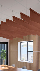 Reddish brown acoustic ceiling blade baffles suspended from the ceiling, installed in a conference room. Felt Right's acoustic blade baffles absorb 65% of sound waves, making office spaces quieter and feel more calm.