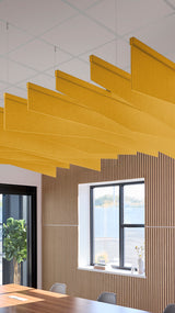Dark yellow acoustic ceiling blade baffles suspended from the ceiling, installed in a conference room. Felt Right's acoustic blade baffles absorb 65% of sound waves, making office spaces quieter and feel more calm.