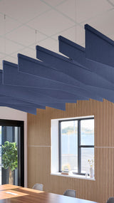 Dark blue acoustic ceiling blade baffles suspended from the ceiling, installed in a conference room. Felt Right's acoustic blade baffles absorb 65% of sound waves, making office spaces quieter and feel more calm.