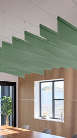 Green acoustic ceiling blade baffles suspended from the ceiling, installed in a conference room. Felt Right's acoustic blade baffles absorb 65% of sound waves, making office spaces quieter and feel more calm.