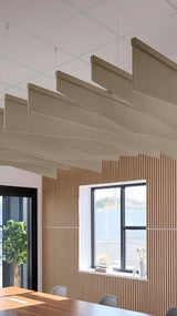 Light brown acoustic ceiling blade baffles suspended from the ceiling, installed in a conference room. Felt Right's acoustic blade baffles absorb 65% of sound waves, making office spaces quieter and feel more calm.