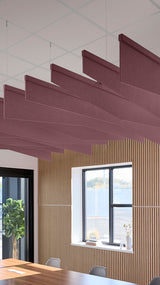 Deep reddish-purple acoustic ceiling blade baffles suspended from the ceiling, installed in a conference room. Felt Right's acoustic blade baffles absorb 65% of sound waves, making office spaces quieter and feel more calm.