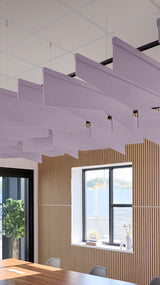 Purple angled acoustic baffles suspended from ceiling in modern office space with wood paneling and windows.