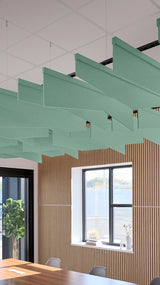 Green angled acoustic baffles suspended from ceiling in modern office space with wood-paneled walls.