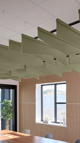 Angled green acoustic baffles suspended from ceiling in modern office space with wooden wall paneling and windows.
