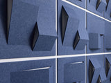 Close-up of blue acoustic panels with geometric cutouts