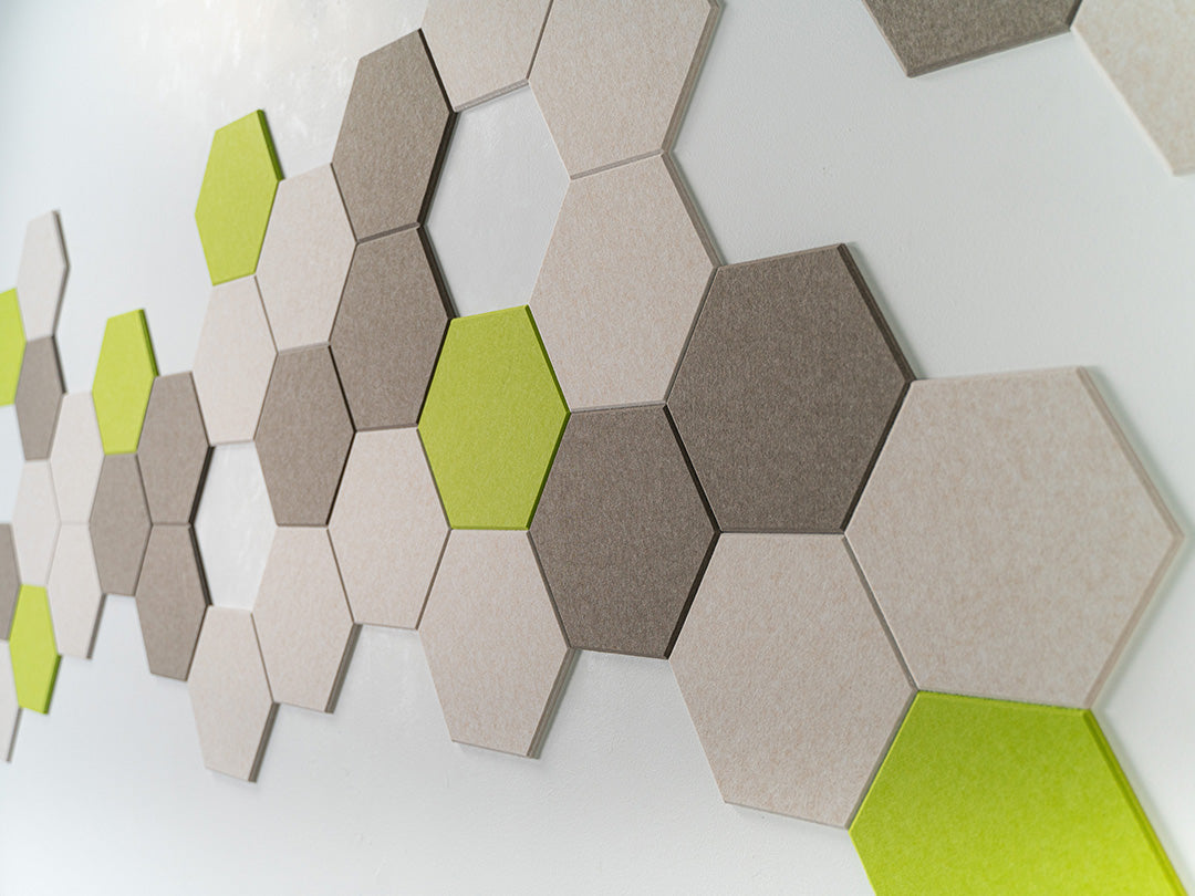 A Felt Right Wall Design on a wall-mounted hexagonal tile artwork in a room featuring shades of green and gray.