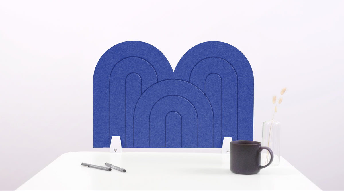 A blue arch-shaped desk divider on a white desk. For the side of your desk.