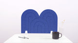 A blue arch-shaped desk divider on a white desk. For the side of your desk.