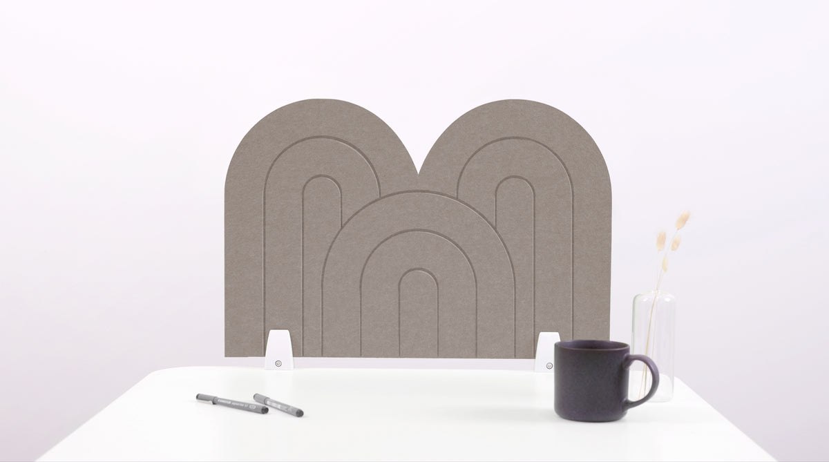 A brown arch-shaped desk divider on a white desk. For the side of your desk.