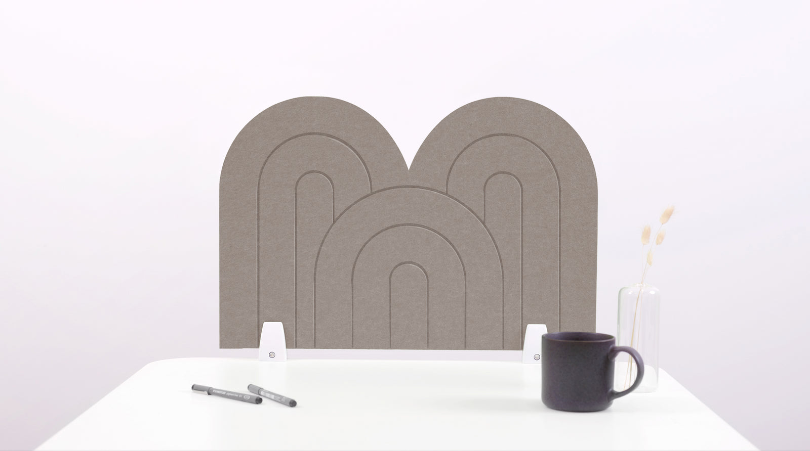A brown arch-shaped desk divider on a white desk. For the side of your desk.