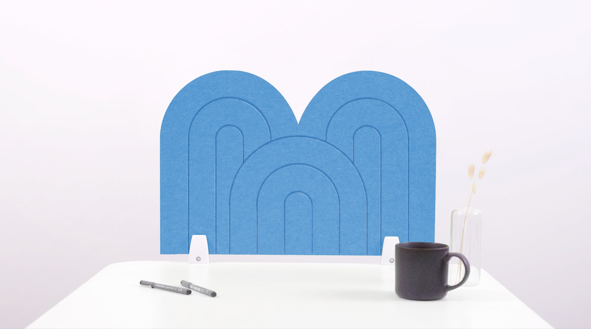 A blue arch-shaped desk divider on a white desk. For the side of your desk.
