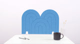A blue arch-shaped desk divider on a white desk. For the side of your desk.