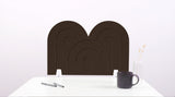 A dark brown arch-shaped desk divider on a white desk. For the side of your desk.