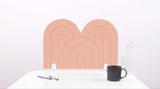 A coral pink arch-shaped desk divider on a white desk. For the side of your desk.