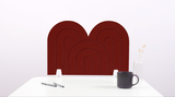 A red arch-shaped desk divider on a white desk. For the side of your desk.