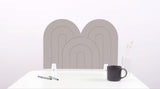 A gray arch-shaped desk divider on a white desk. For the side of your desk.