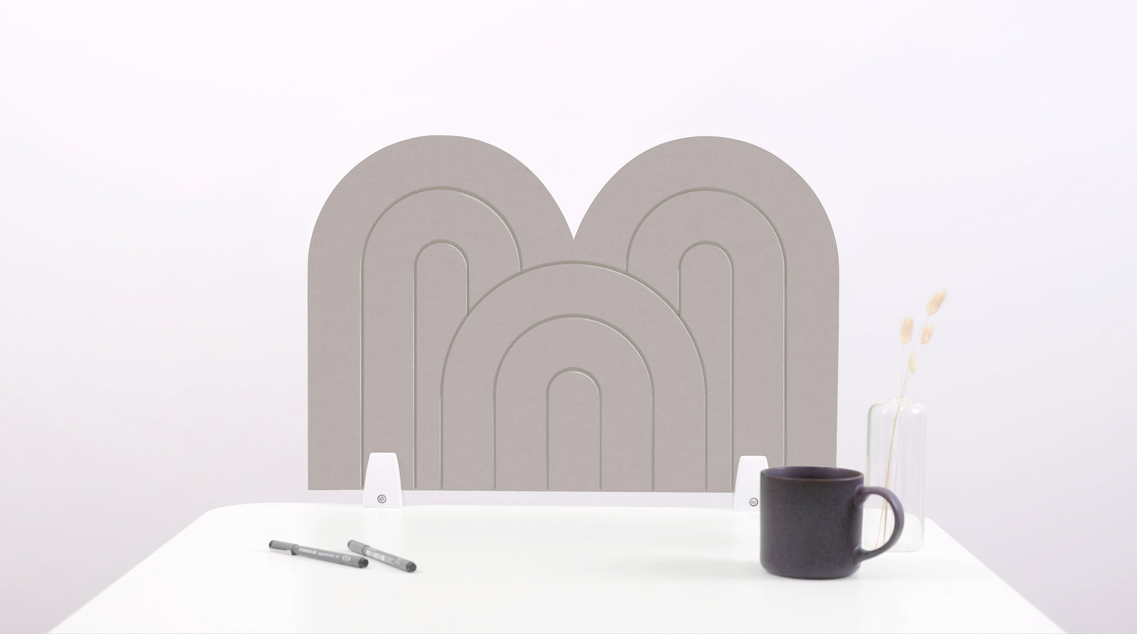 A gray arch-shaped desk divider on a white desk. For the side of your desk.