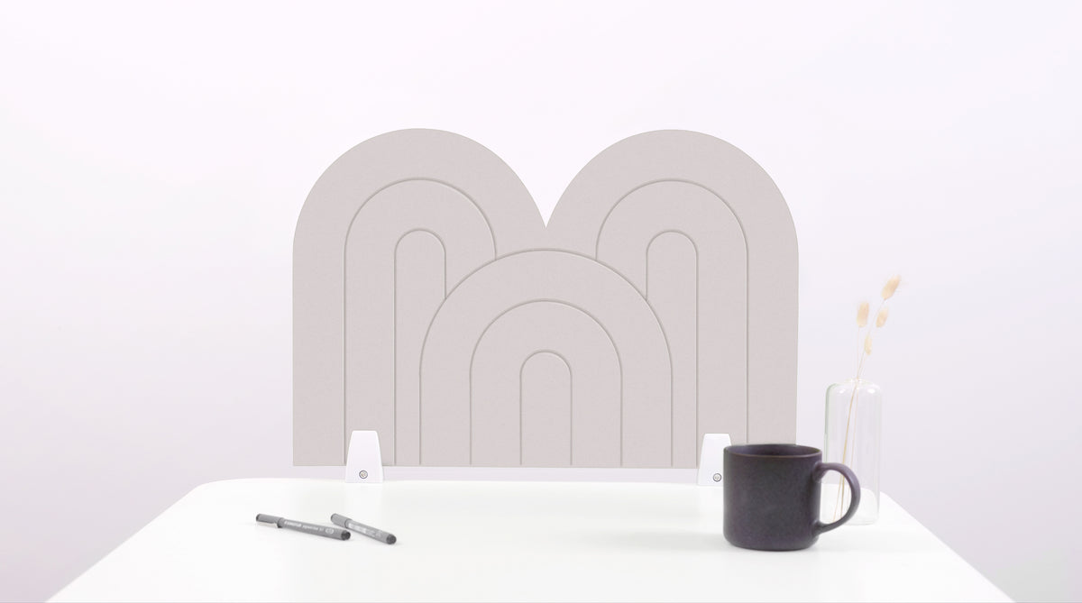 A white arch-shaped desk divider on a white desk. For the side of your desk.