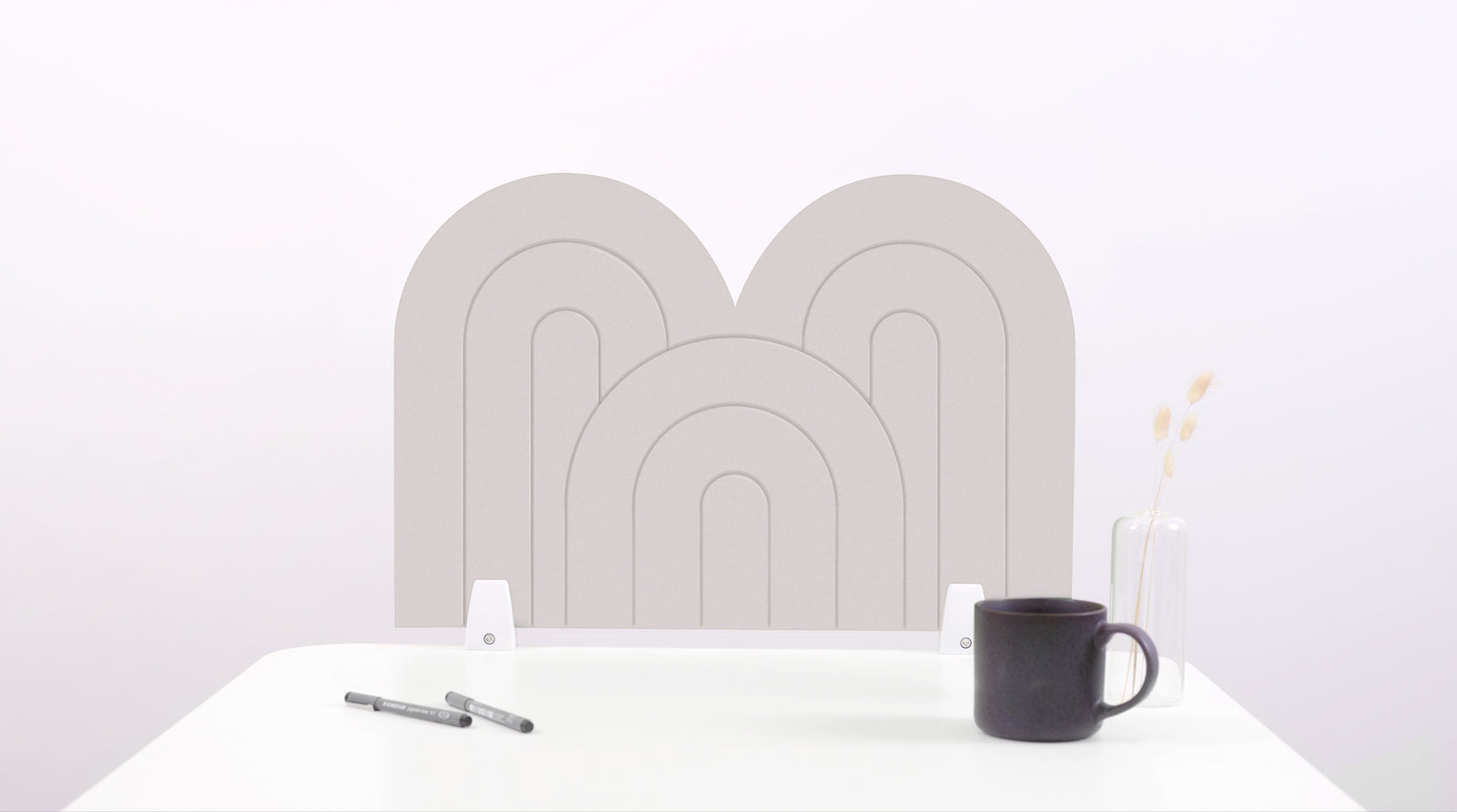 A white arch-shaped desk divider on a white desk. For the side of your desk.