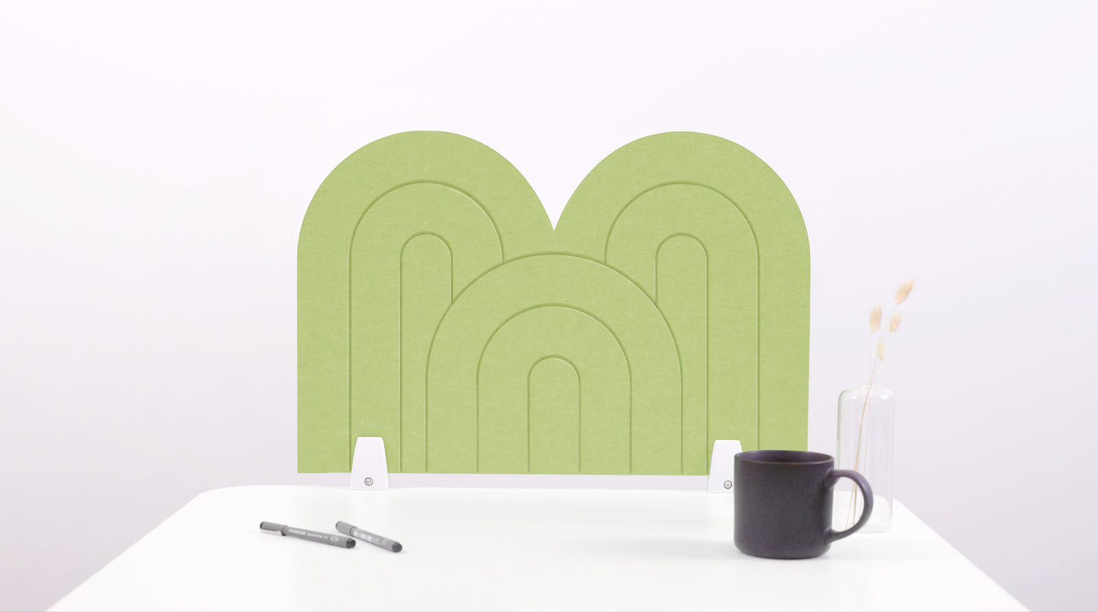 A light green arch-shaped desk divider on a white desk. For the side of your desk.