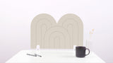 A latte colored arch-shaped desk divider on a white desk. For the side of your desk.