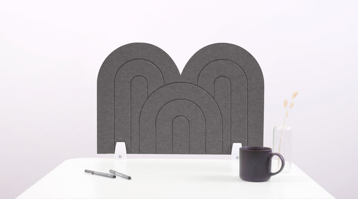 A gray arch-shaped desk divider on a white desk. For the side of your desk.