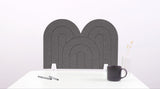 A gray arch-shaped desk divider on a white desk. For the side of your desk.