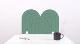 A mint green arch-shaped desk divider on a white desk. For the side of your desk.