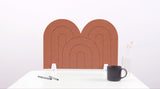 A moab colored arch-shaped desk divider on a white desk. For the side of your desk.