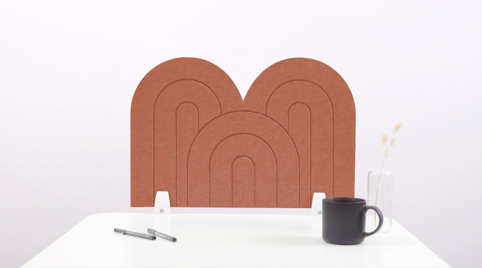 A moab colored arch-shaped desk divider on a white desk. For the side of your desk.