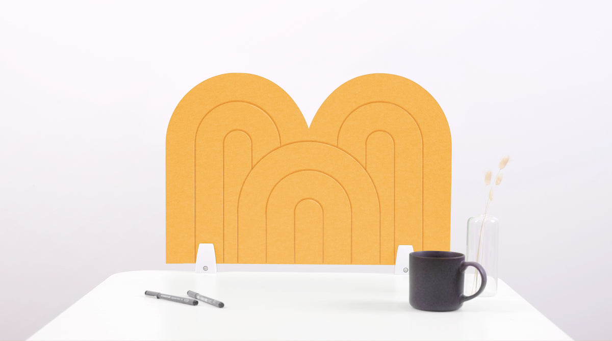 A mustard yellow arch-shaped desk divider on a white desk. For the side of your desk.