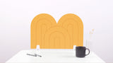 A mustard yellow arch-shaped desk divider on a white desk. For the side of your desk.