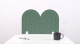 A green arch-shaped desk divider on a white desk. For the side of your desk.