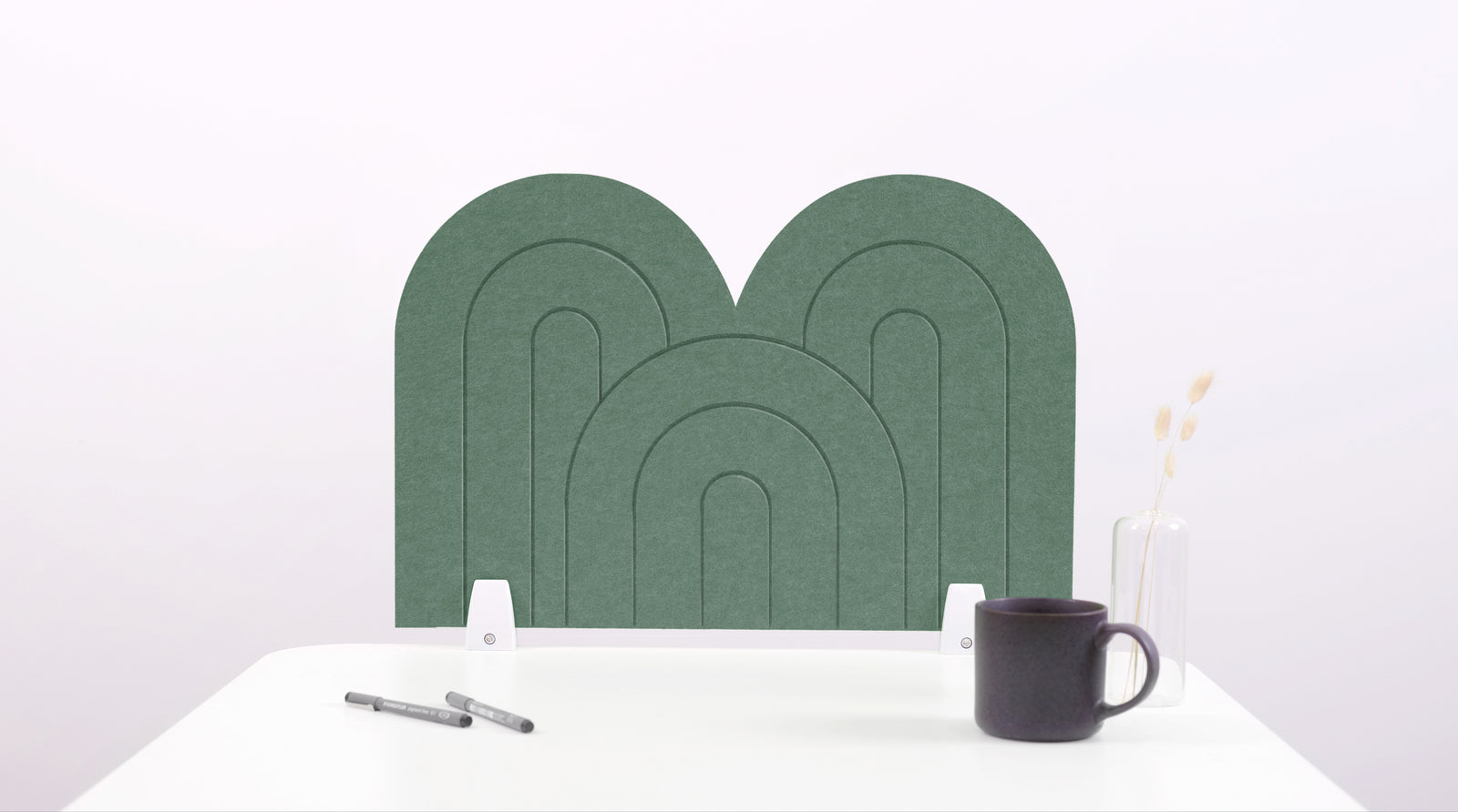 A green arch-shaped desk divider on a white desk. For the side of your desk.