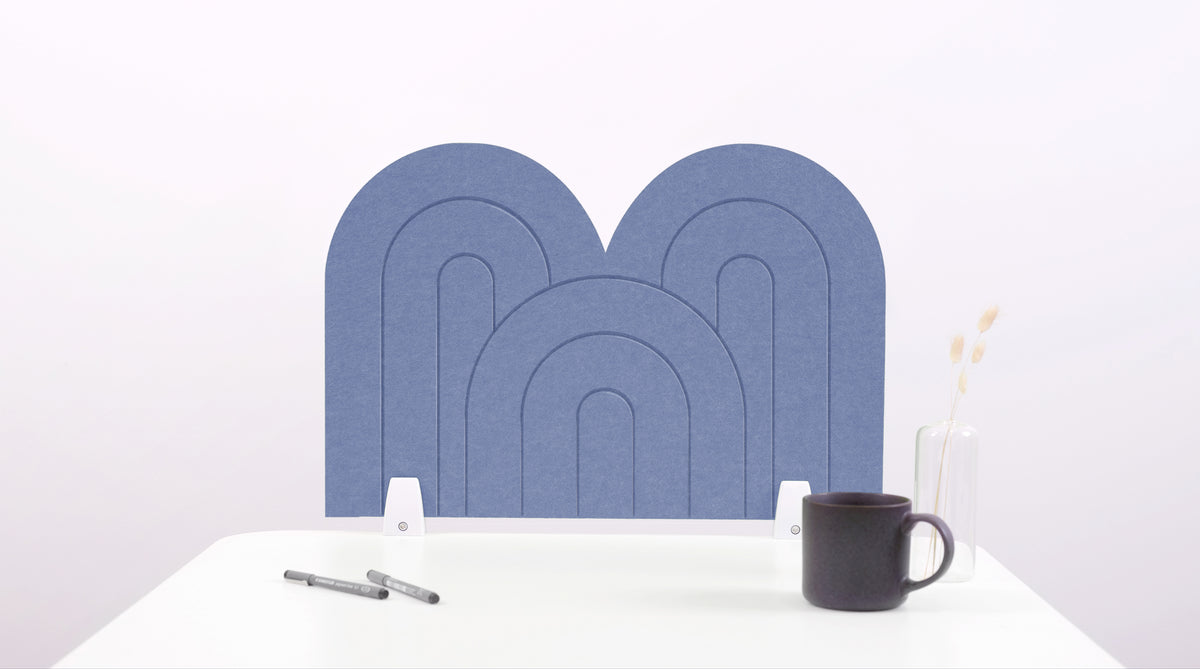 A purple/blue arch-shaped desk divider on a white desk. For the side of your desk.