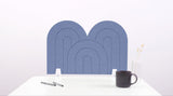 A purple/blue arch-shaped desk divider on a white desk. For the side of your desk.