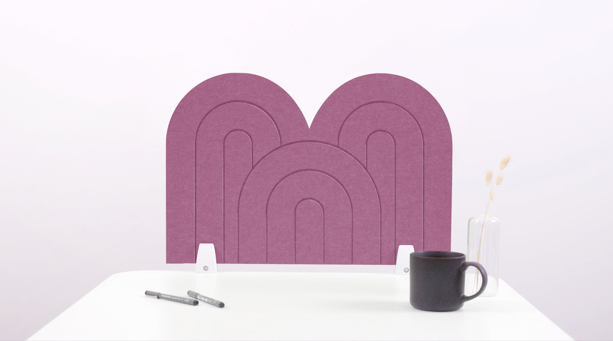 A pink arch-shaped desk divider on a white desk. For the side of your desk.