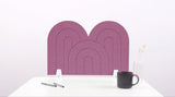 A pink arch-shaped desk divider on a white desk. For the side of your desk.