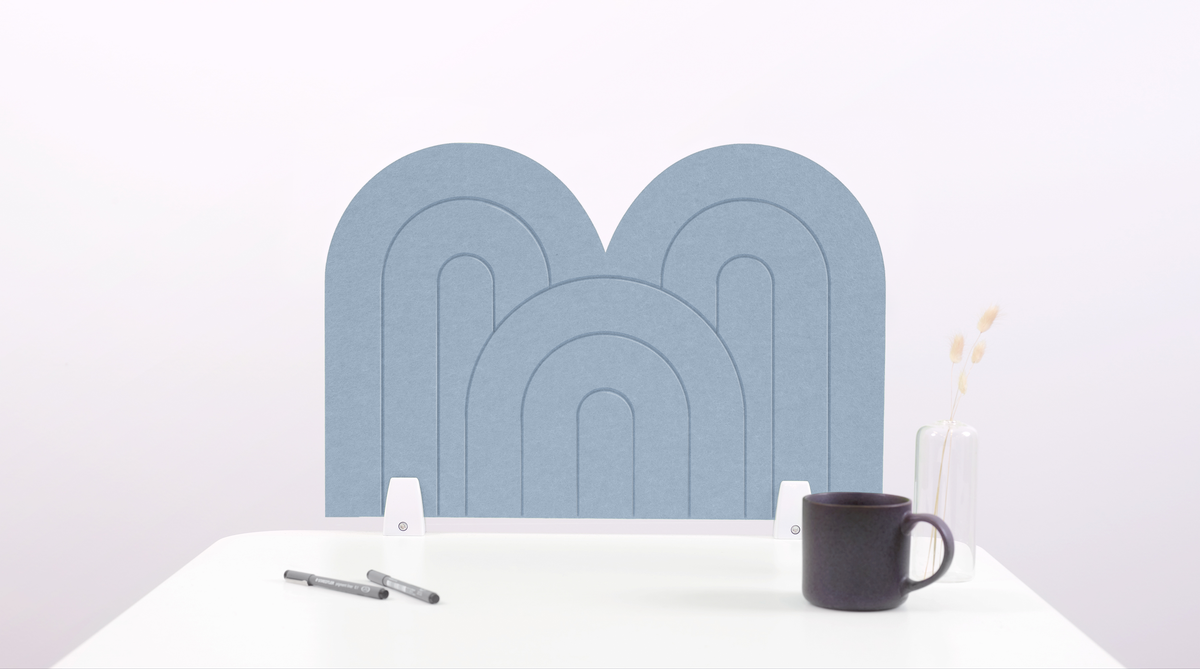A light blue arch-shaped desk divider on a white desk. For the side of your desk.
