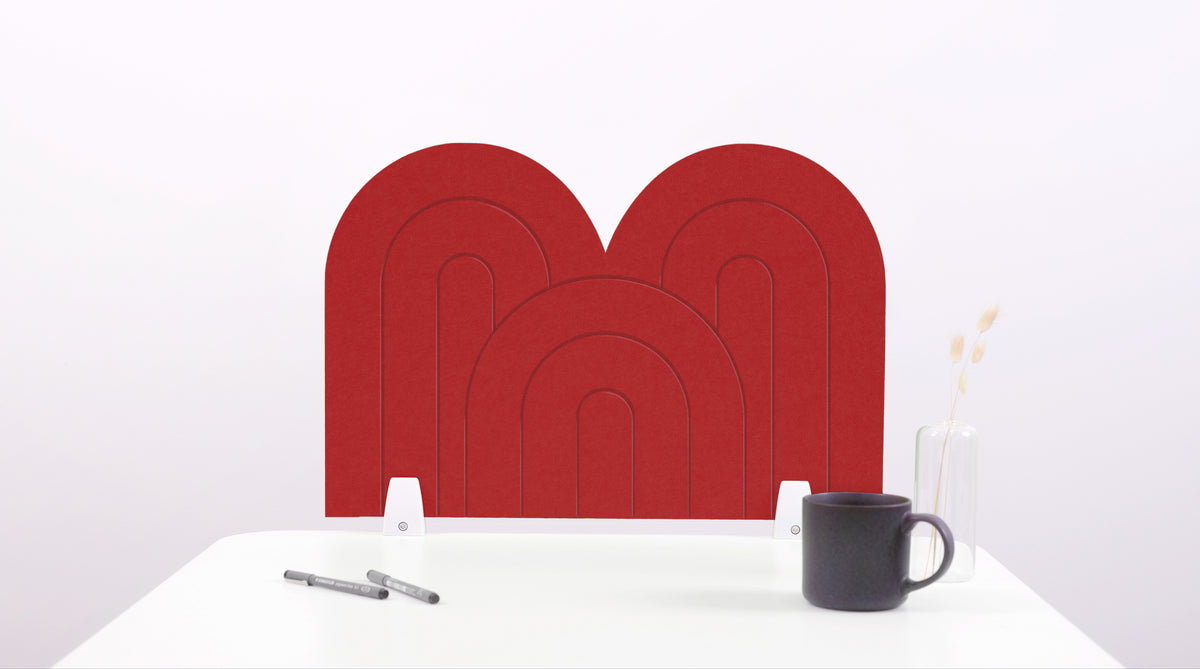 A red arch-shaped desk divider on a white desk. For the side of your desk.
