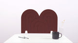 A brown arch-shaped desk divider on a white desk. For the side of your desk.