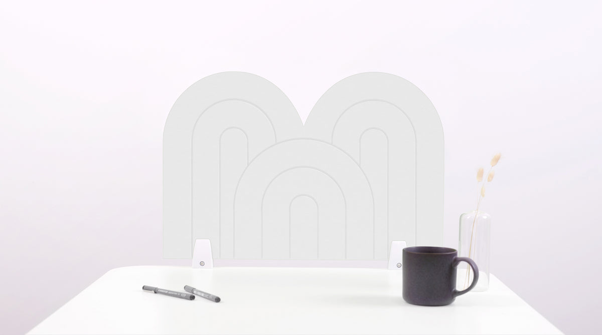 A white arch-shaped desk divider on a white desk. For the side of your desk.