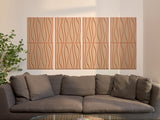 Four-panel wall art with wavy line pattern in beige and tan tones above gray upholstered sofa.