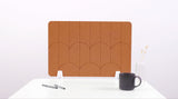 A cinnamon colored felt desk divider with a scalloped design of lines and arches. 